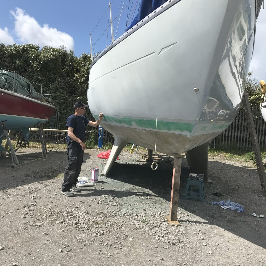 Les prepping the hull on Ocean Strider. Budget electric sailboat conversion.