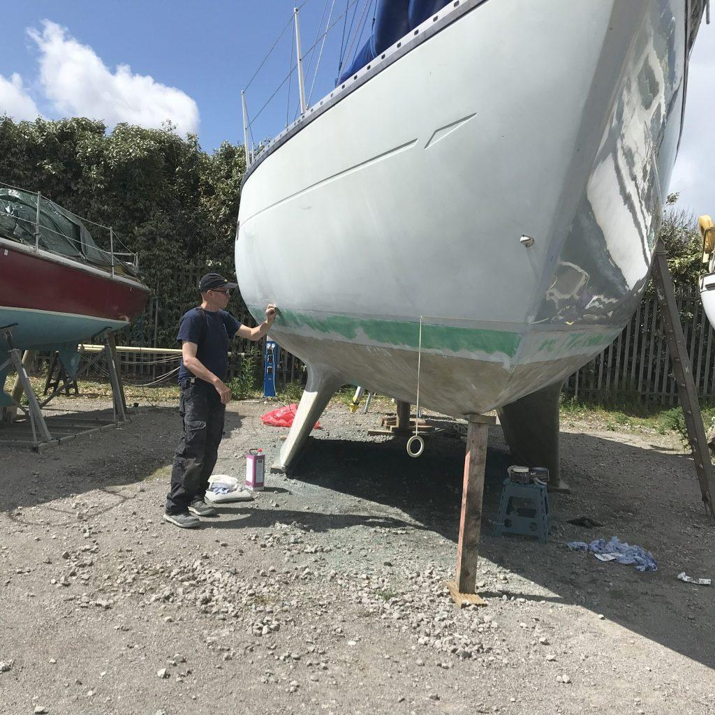 Les prepping the hull on Ocean Strider. Budget electric sailboat conversion.